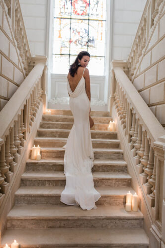 londigny k.lundford bride back shot long trail low back white dress vintage stairs candles