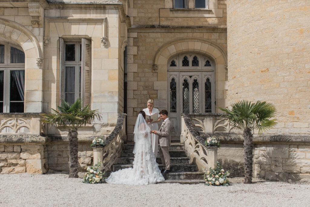 londigny k.lundford bride groom changing vows outside castle