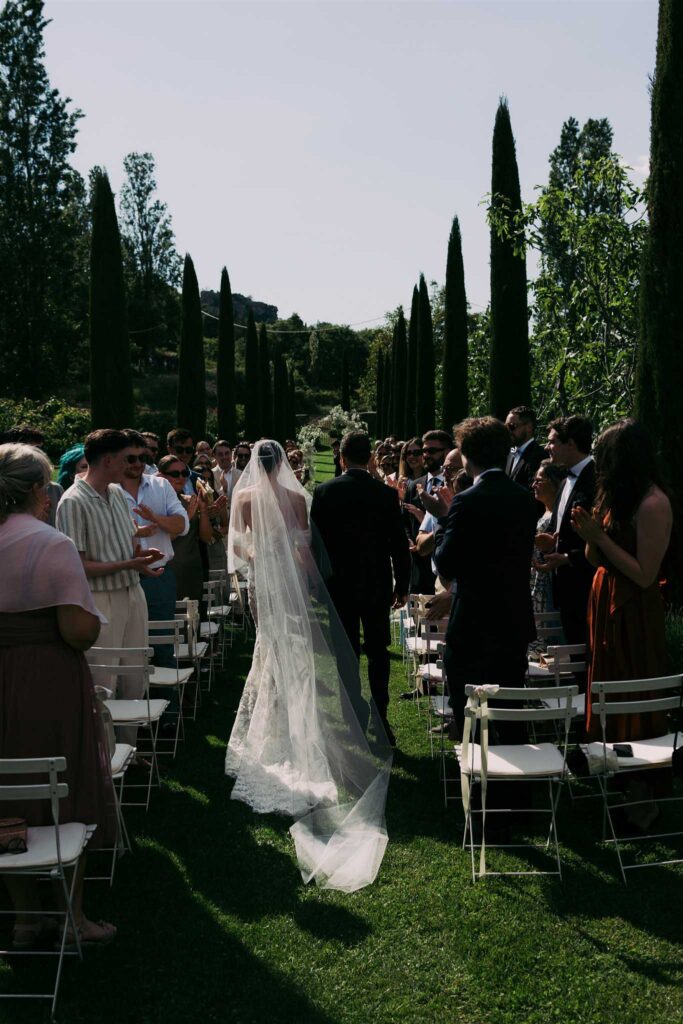 saint eusebe ayata couple backshot ceremony aisle guests clapping