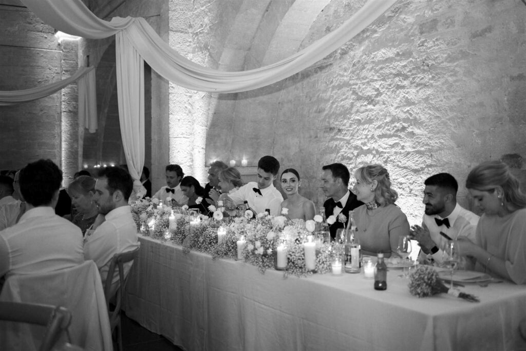 saint eusebe ayata long reception table bride groom black white photo