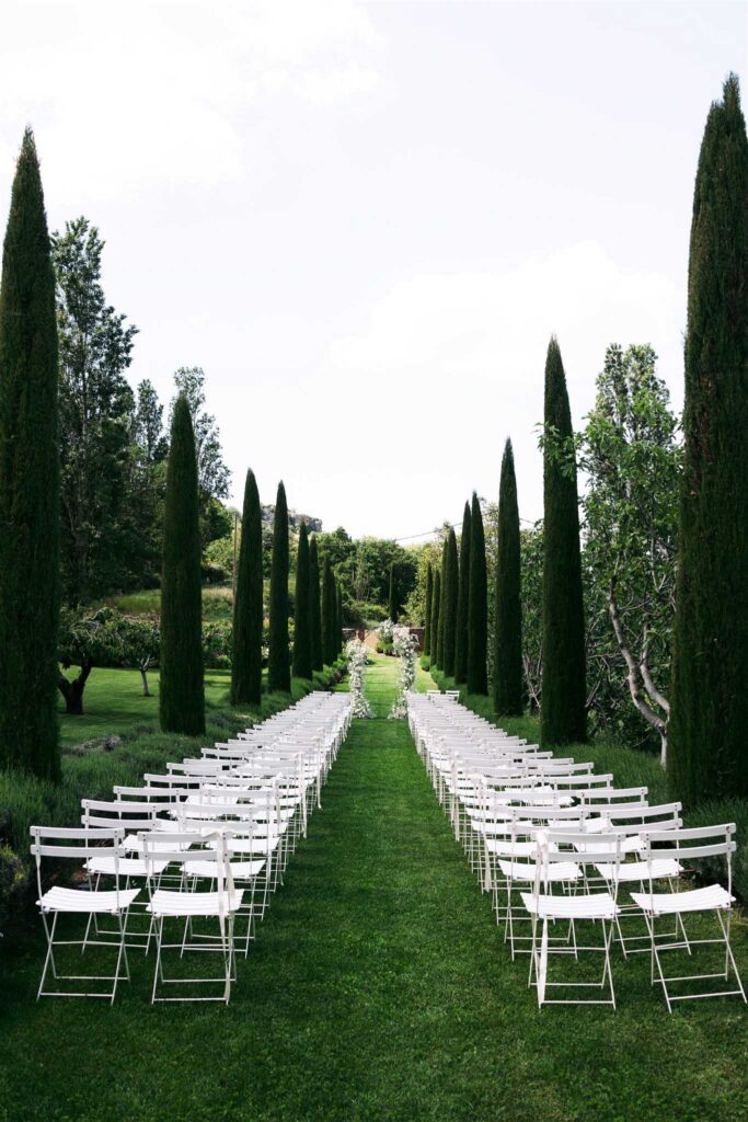 saint eusebe ayata white chairs long pine trees aisle ceremony