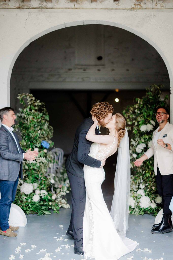 Trieux M.Mann bride groom kissing after ceremony