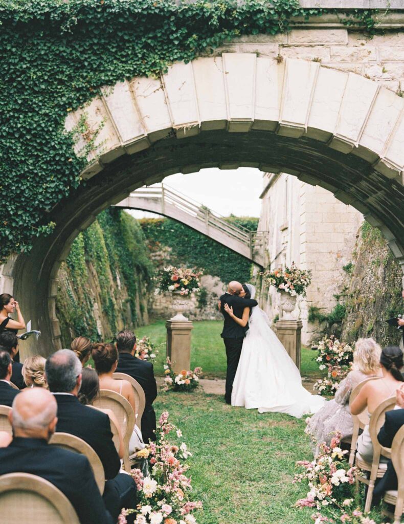 de Jalesne S.Lord bride groom kissing under bridge ceremony