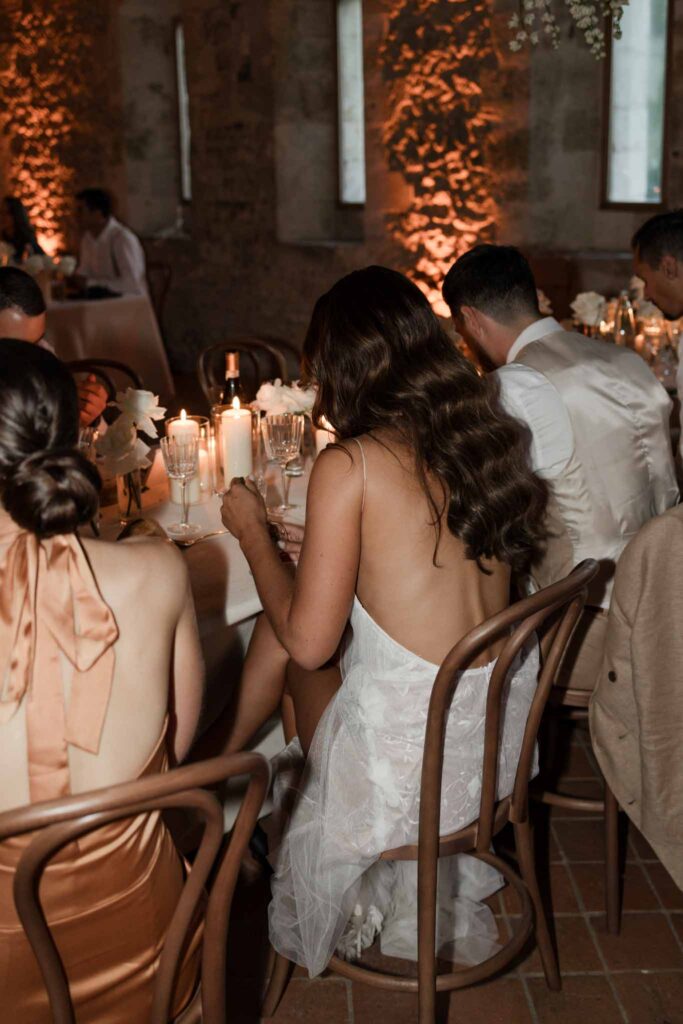 Abbaye Noce Machine detail shot low back dress sitting bride reception