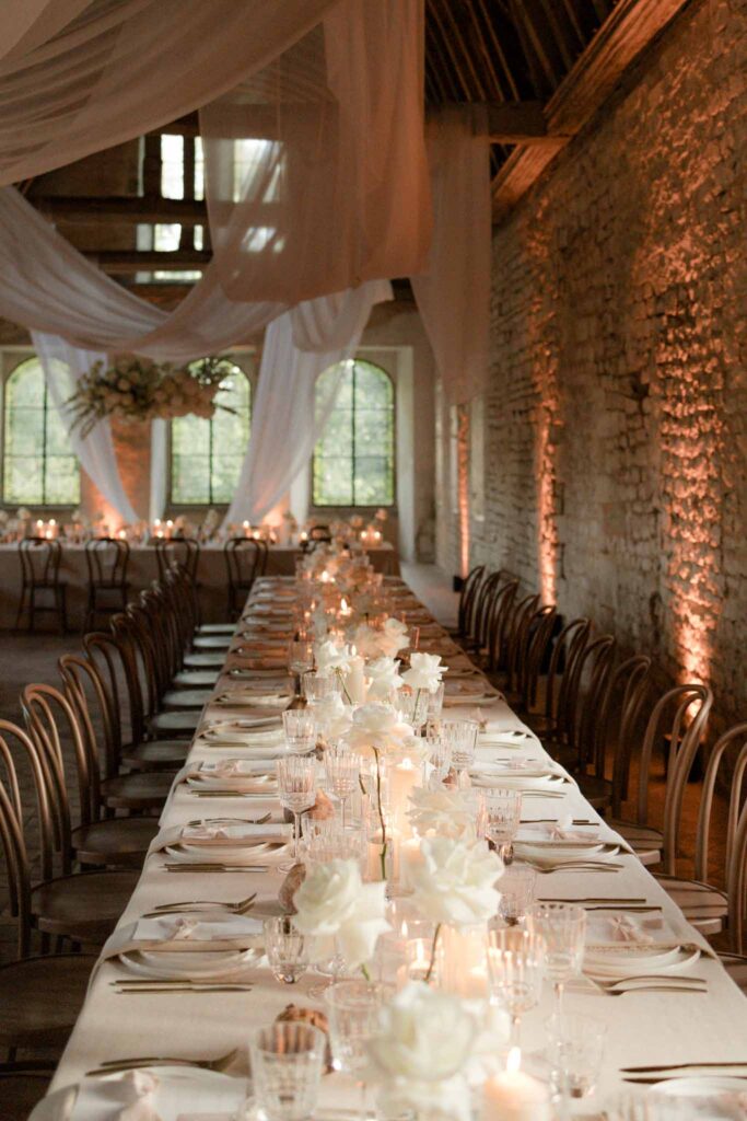 Abbaye Noce Machine long reception table inside ruined old structure candle lit