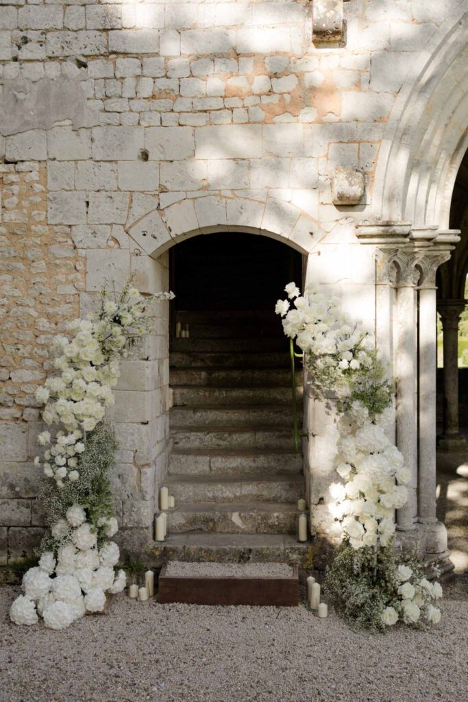 Abbaye Noce Machine white flower towers entrance reception area old structure