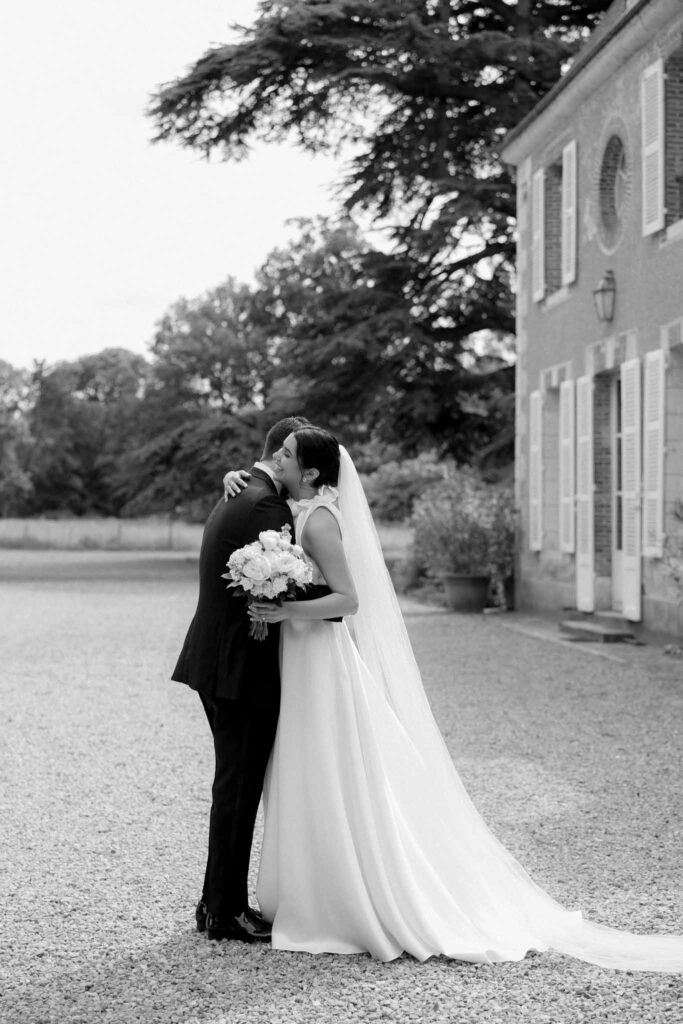 Boutonvillier F.Mary bride groom hugging after first look black white photo