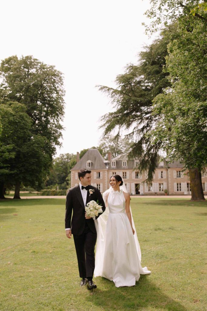 Boutonvillier F.Mary bride groom looking each other walking green trees background