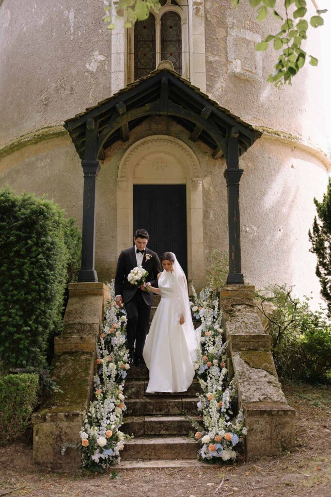 Boutonvillier F.Mary bride groom walking down stairs chapel flowers on side