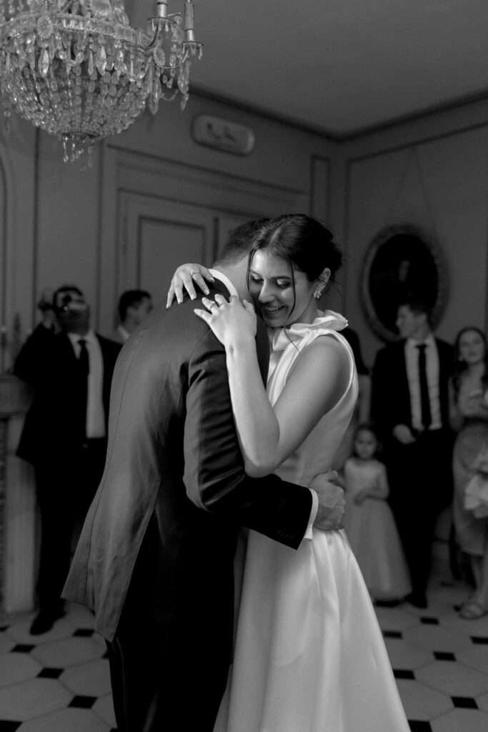 Boutonvillier F.Mary bride hugging groom while dancing black white photo side angle