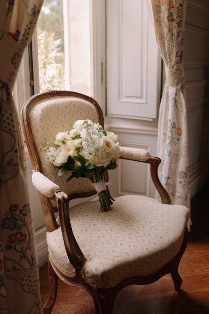 Boutonvillier F.Mary white bouquet on vintage chair by the window