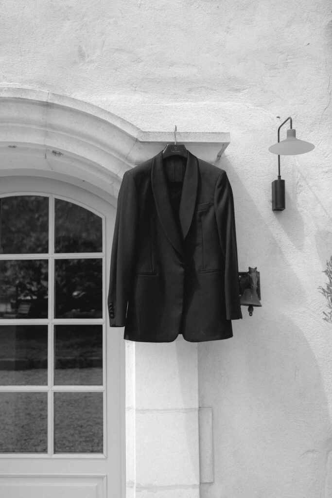 Chateau de Martinay Despinoy Wedding black tuxedo hanging by window