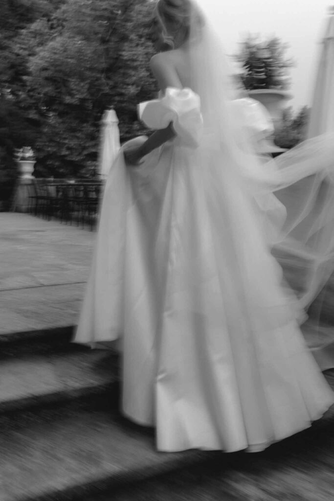 Chateau de Martinay Despinoy Wedding blurry shot bride off shoulder dress long veil black white photo