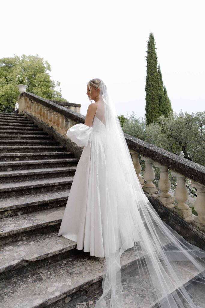 Chateau de Martinay Despinoy Wedding bride by the stairs long veil updo hair