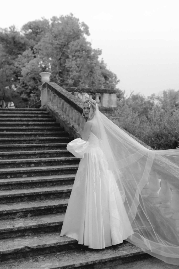 Chateau de Martinay Despinoy Wedding bride by the stairs long veil updo hair black white photo