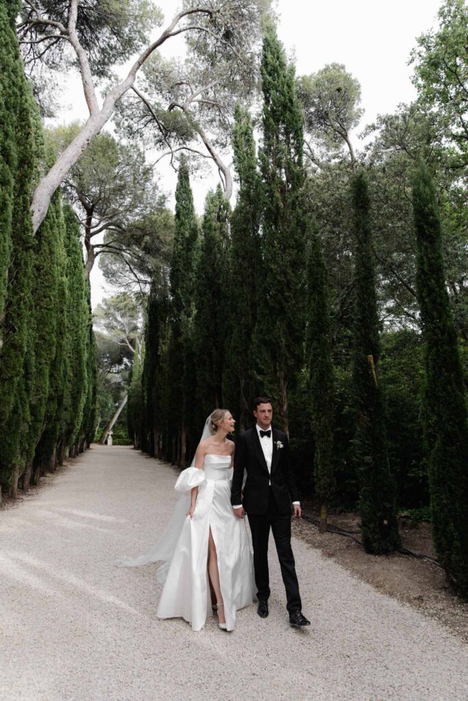 Chateau de Martinay Despinoy Wedding bride groom holding hands lined trees clear road