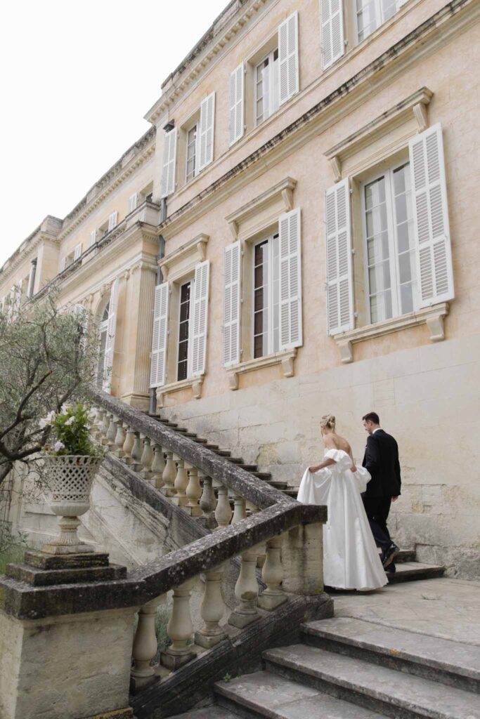 Chateau de Martinay Despinoy Wedding bride groom holding hands walking upstairs outside venue