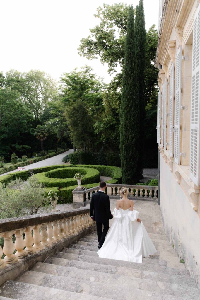 Chateau de Martinay Despinoy Wedding bride groom walking down stairs outside chateau