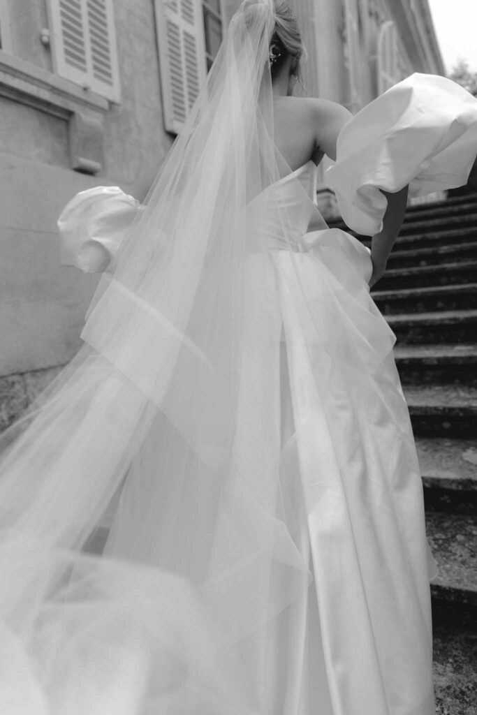 Chateau de Martinay Despinoy Wedding bride running up stairs long veil black white photo