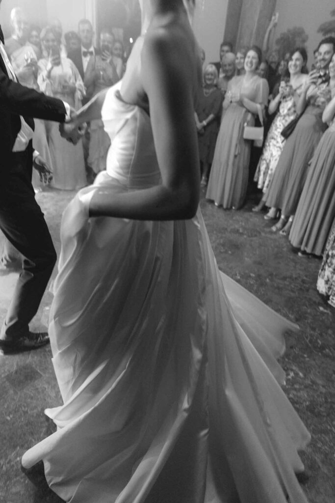 Chateau de Martinay Despinoy Wedding detail shot brides strapless dress twirling guests background