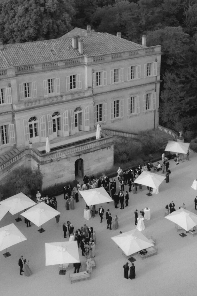 Chateau de Martinay Despinoy Wedding drone shot cocktail area umbrella guests standing