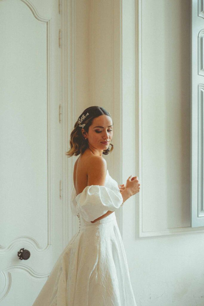 L Amour Fou 3 Maude C Photographe bride looking over shoulder off shoulders dress