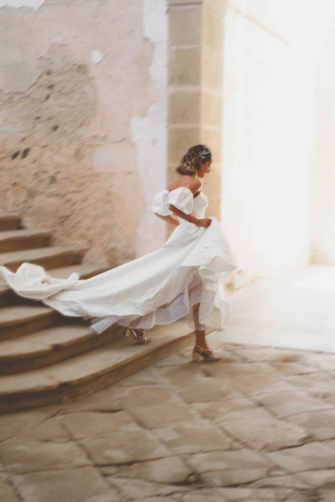 L Amour Fou 3 Maude C Photographe bride running holding gown down stairs