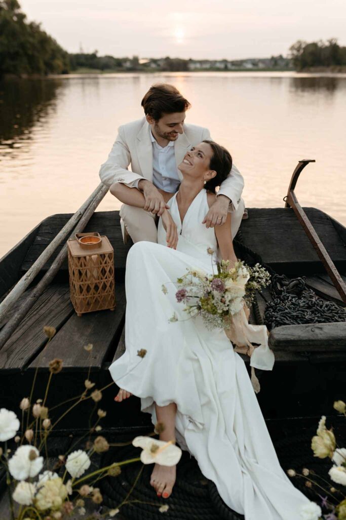 Loire Valley Il Keys bride groom sitting end boat looking each other