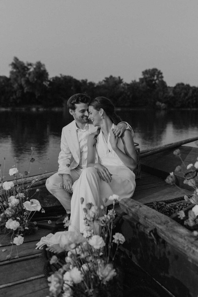 Loire Valley Il Keys bride groom sitting on boat flower decor black white photo