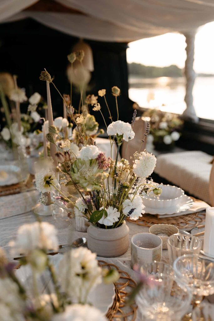 Loire Valley Il Keys detail shot white flowers ceramics glassware reception table