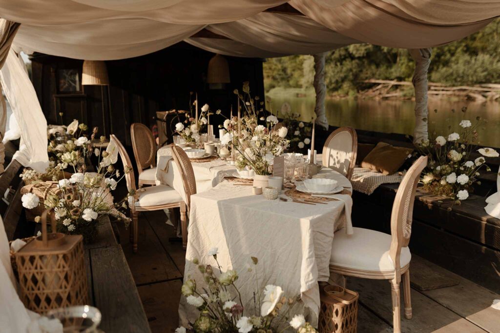 Loire Valley Il Keys rustic reception by the boat white flower decor wood tables chairs design