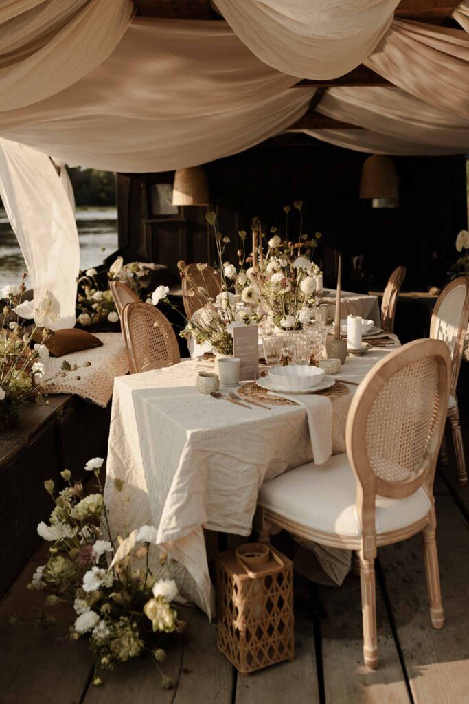 Loire Valley Il Keys rustic vintage reception set up white wood chairs flowers white cloth ceiling