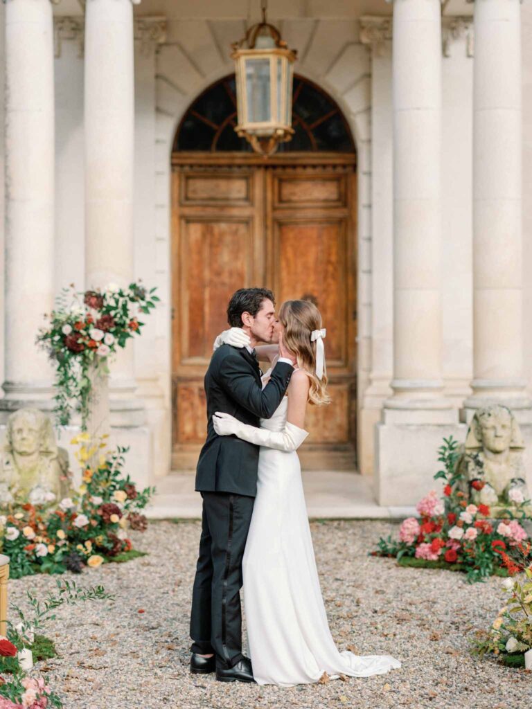 Marcellus Q.H.Quinze bride groom kissing old door background