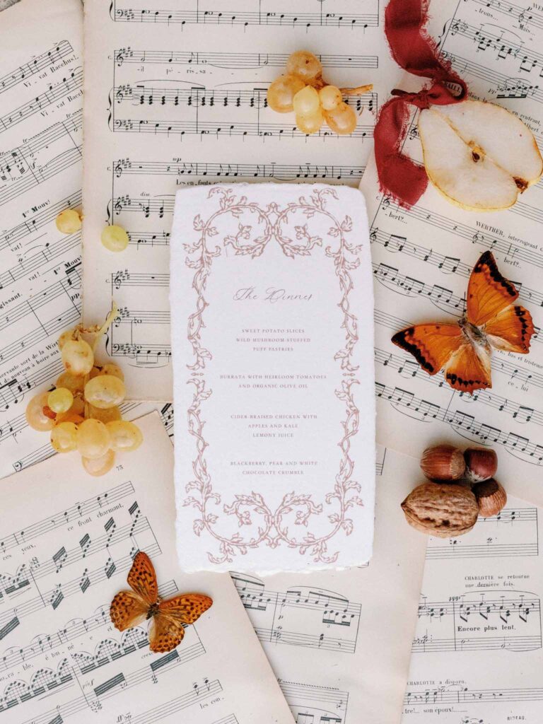 Marcellus Q.H.Quinze menu card flatlay shot with vintage music notes background fruits butterfly