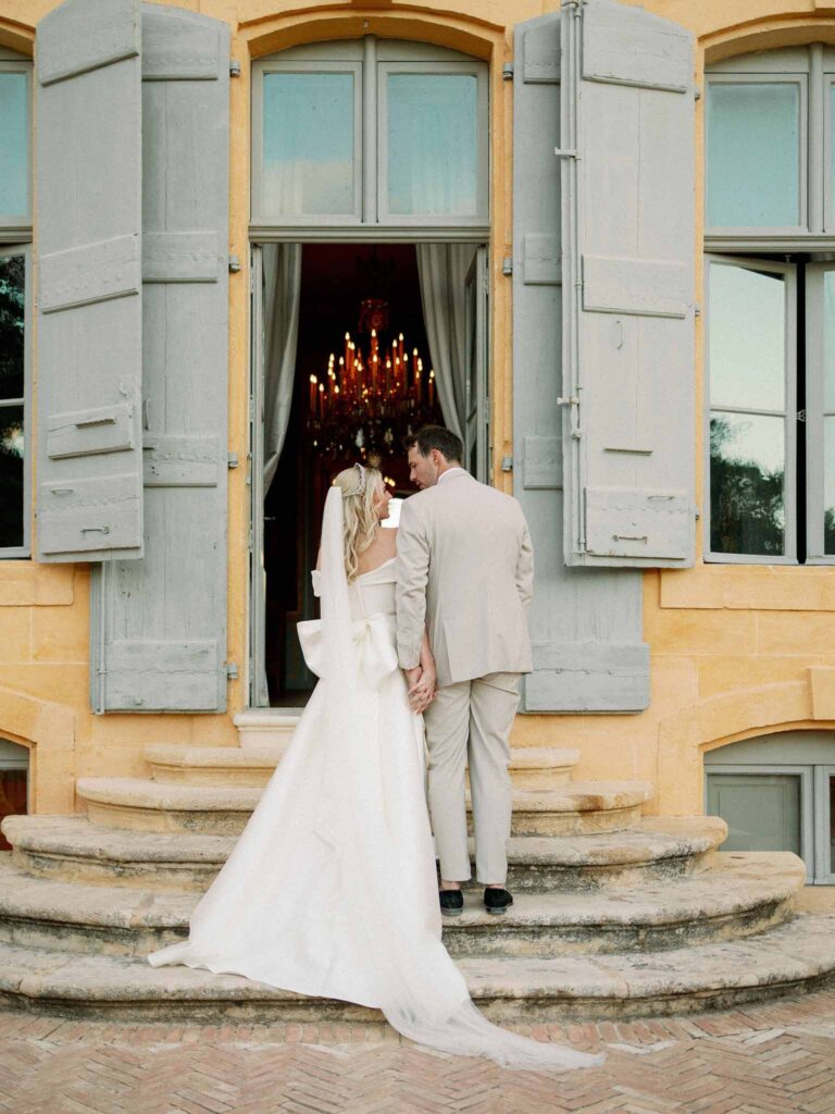 g.dominic m.marechal bride groom backshot outside chateau