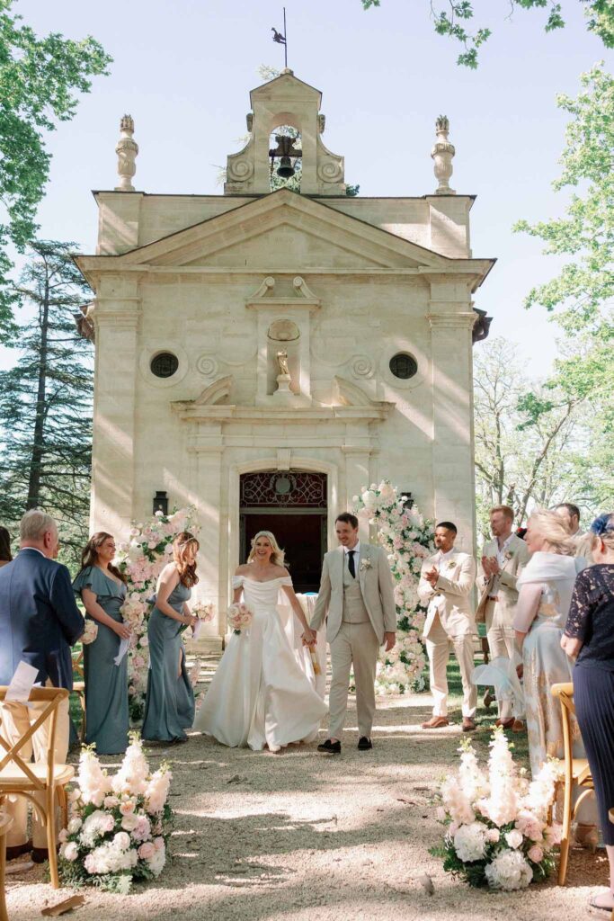 g.dominic m.marechal bride groom walking out ceremony guests clapping