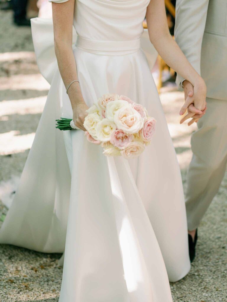 g.dominic m.marechal bride white blush boquet while holding hands groom