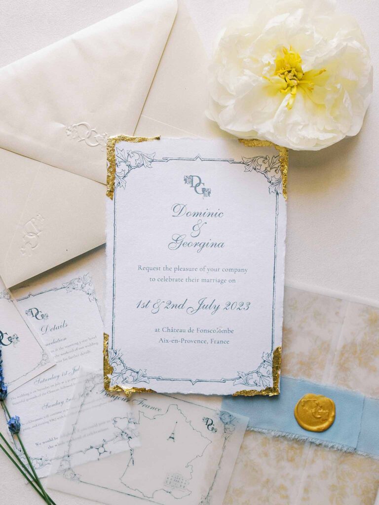 g.dominic m.marechal invitation gold blue accent flatlay shot