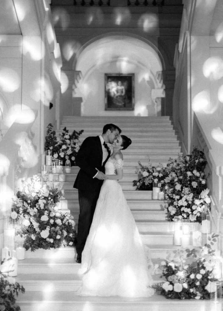 saint martin H.Clark groom kissing bride stairs floral design