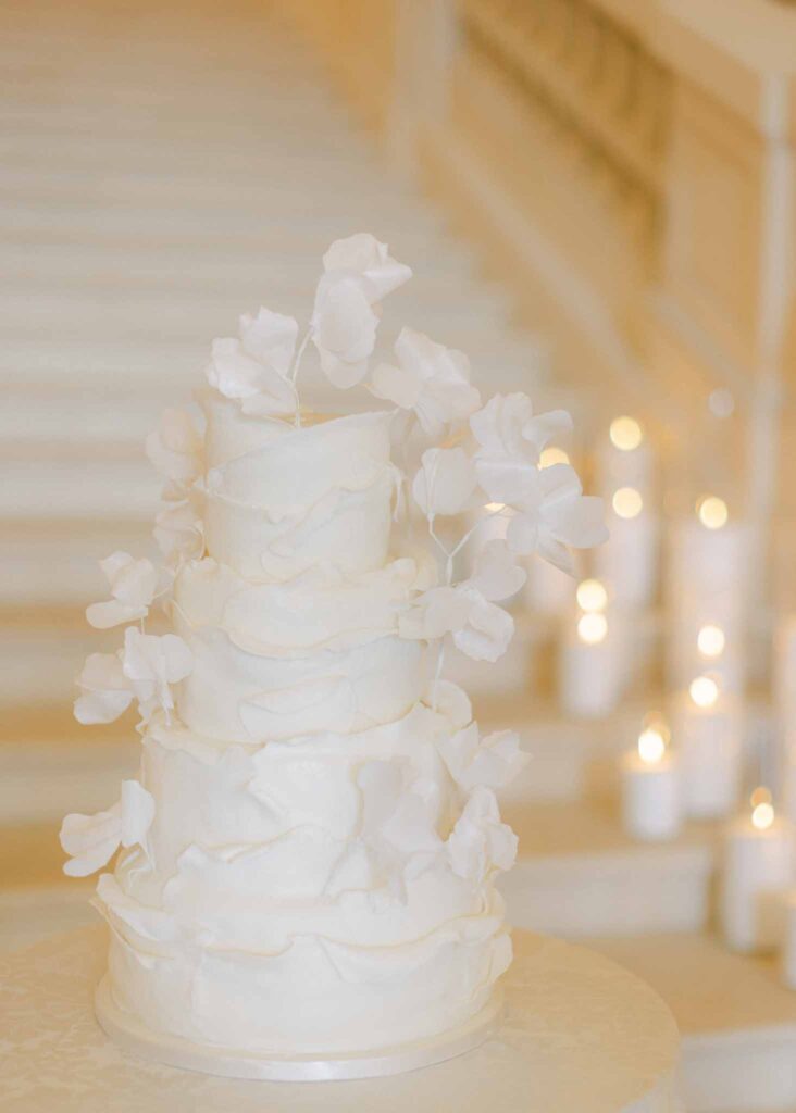 saint martin H.Clark three tier white wedding cake floral