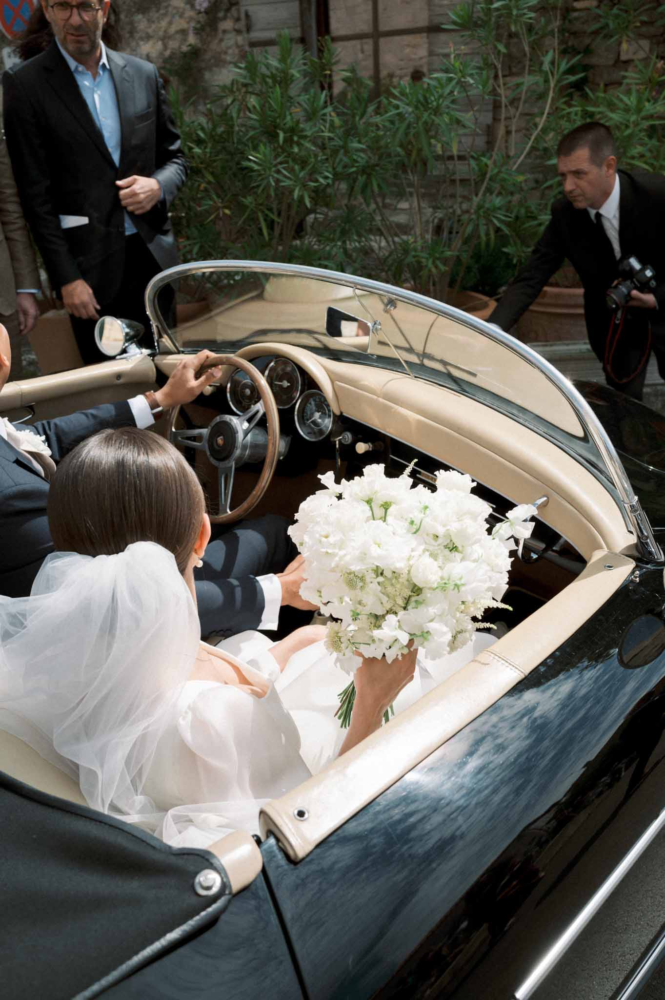 Abbaye Saint Eusebe Jasmin Peonies bride groom inside vintage black car after ceremony