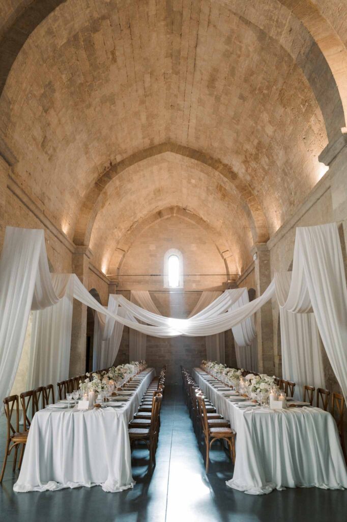 Abbaye Saint Eusebe Jasmin Peonies two long tables ceiling white cloth draping