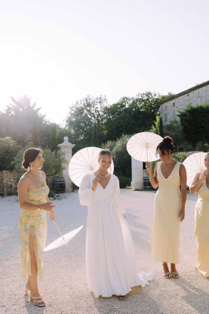 Clos d Hullias Ozaria bride bridesmaids holding white japanese umbrellas candid shot