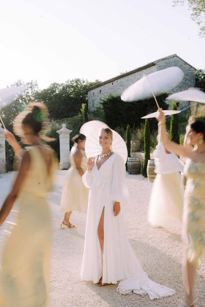 Clos d Hullias Ozaria bride bridesmaids walking circle the bride holding umbrella