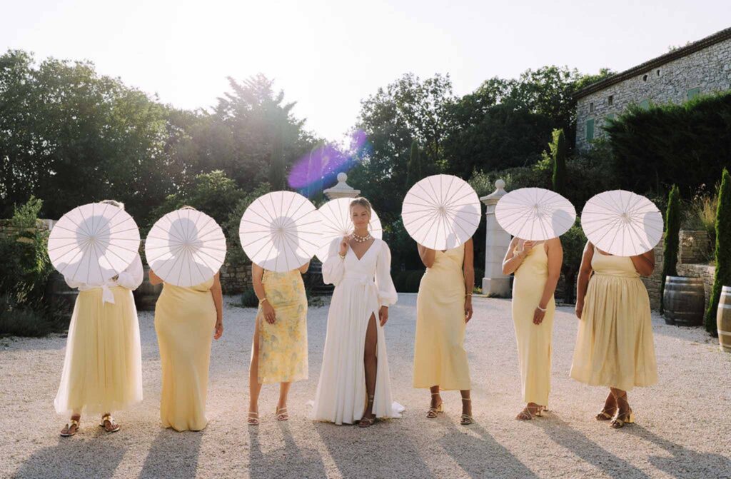 Clos d Hullias Ozaria bride facing camera bridesmaids umbrellas in front face