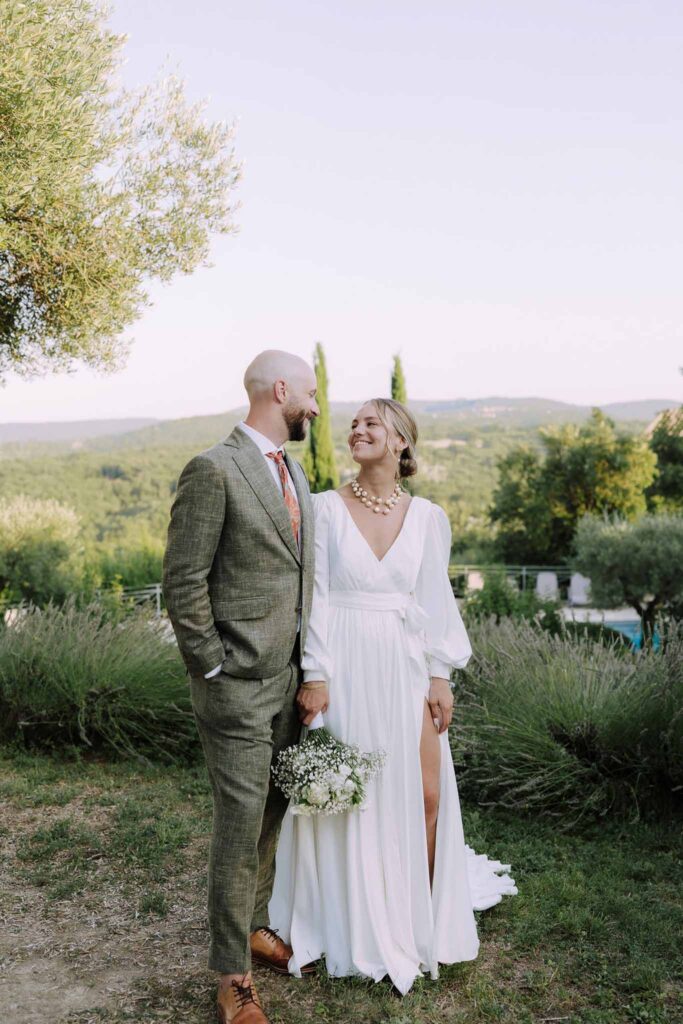 Clos d Hullias Ozaria bride groom looking each other field green trees background