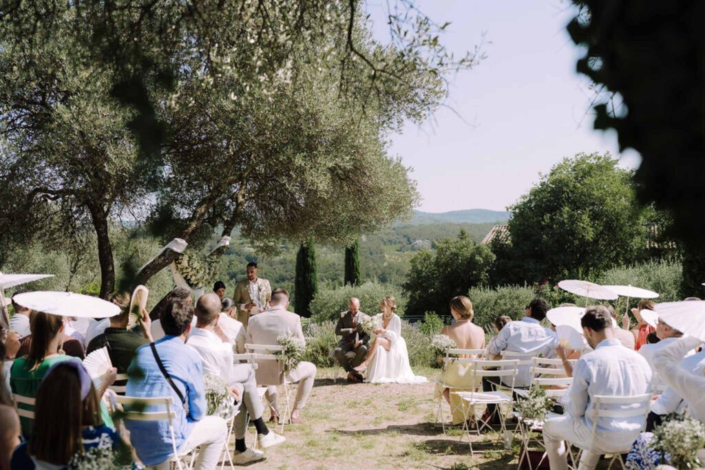 Clos d Hullias Ozaria bride groom sitting front ceremony guests sitting