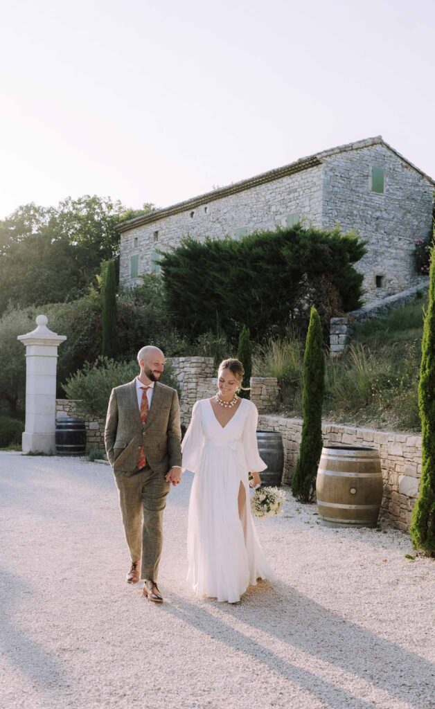 Clos d Hullias Ozaria bride groom walking holding hands sunset