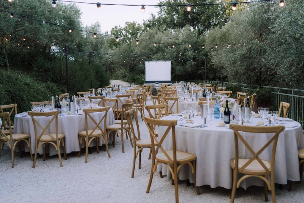 Clos d Hullias Ozaria circle table wood chairs stringlights projector reception