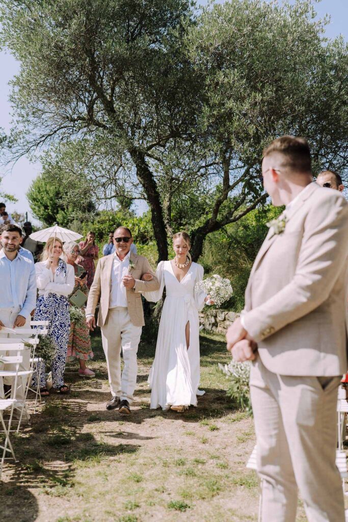 Clos d Hullias Ozaria flatlay bride father walking down aisle guests standing